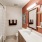 lighted bathroom with shower/tub combo