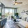private balcony access in living room with ceiling fan and lighting fixture