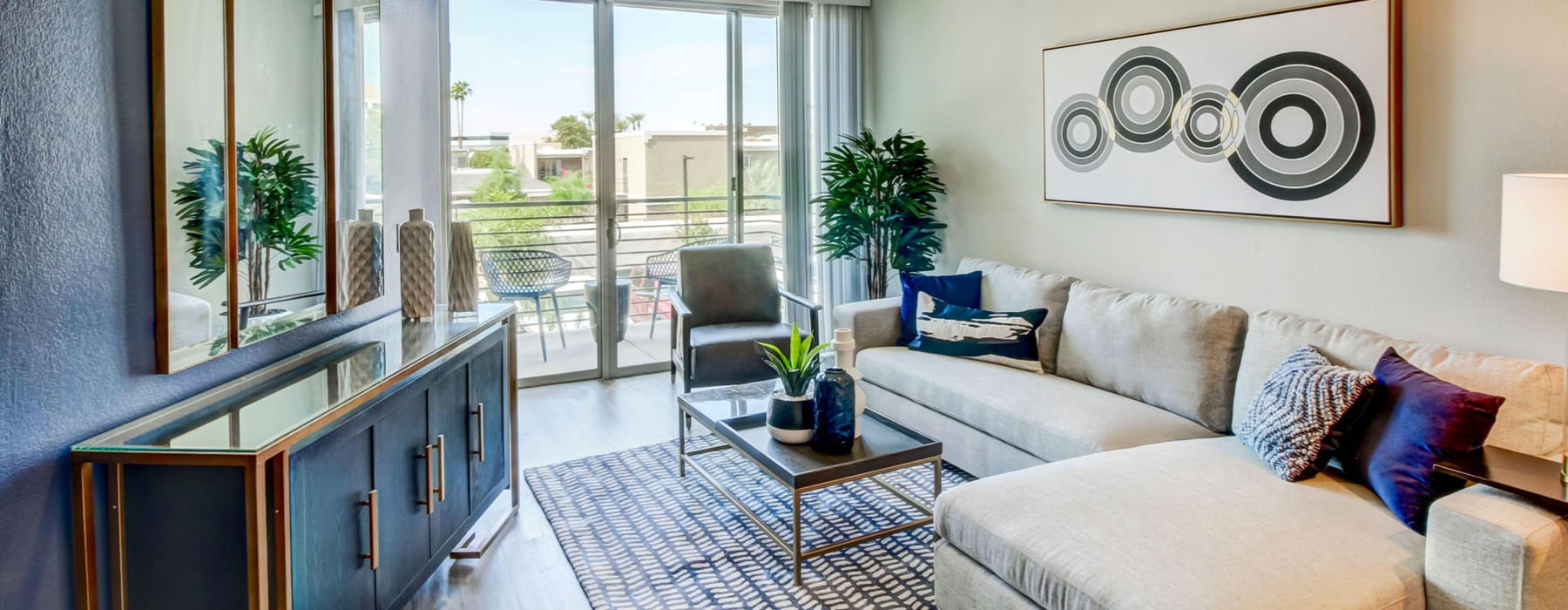 glass doors with private balcony access brightens living room